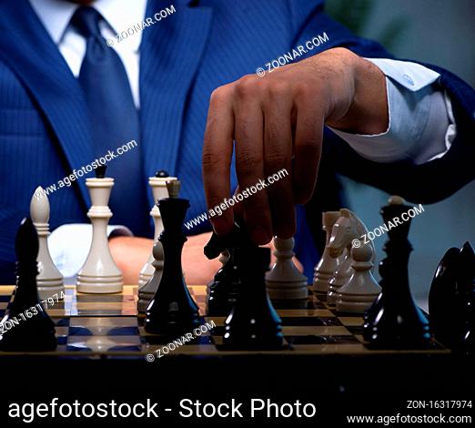 The businessman playing chess in strategy concept