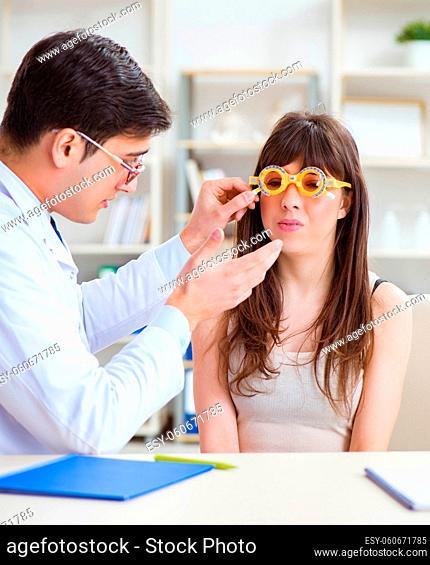 The ophthalmologist is checking up patient in eye doctor hospital