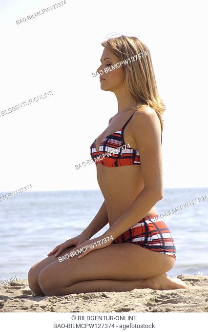 Woman sits on the beach