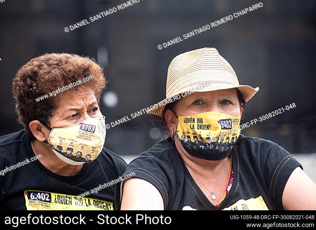 Mothers of relatives killed during the flase positives with shirts and a face masks that reads ""Who gave the order?"" with photos of army an police generals...