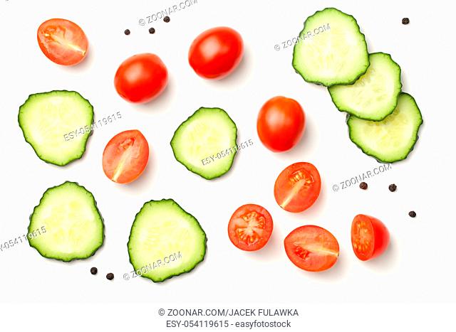 Red pepper cherry tomatoes with cucumber and peppercorn isolated on white background. Top view