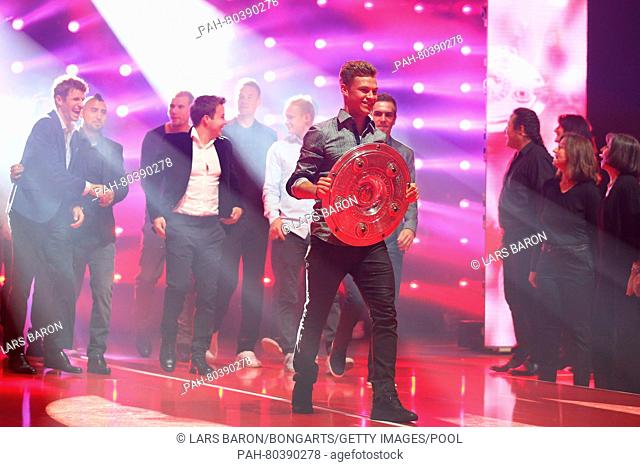 MUNICH, GERMANY - MAY 14: Joshua Kimmich walks out with The Meisterschale, the trophy of the German football championship during the FC Bayern Muenchen...