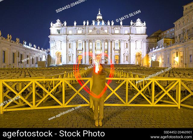 Woman Light Painting a Heart shape in Front of Vatican City in Rome, Italy