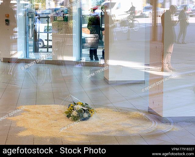 Illustration picture shows flowers on the floor where a victim was yesterday on the site of Monday's attack, the entrance to an office building, in Brussel