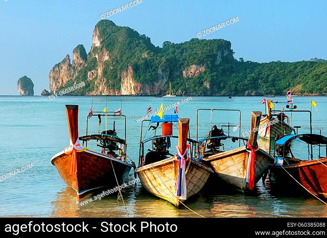 Longtail boats anchored at Ao Loh Dalum beach on Phi Phi Don Island, Krabi Province, Thailand. Koh Phi Phi Don is part of a marine national park