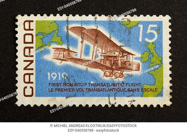 CANADA - CIRCA 1980: Stamp printed in Canada shows a world map and a airplane (1919), circa 1980