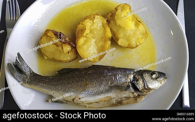 Baked bass with potatoes