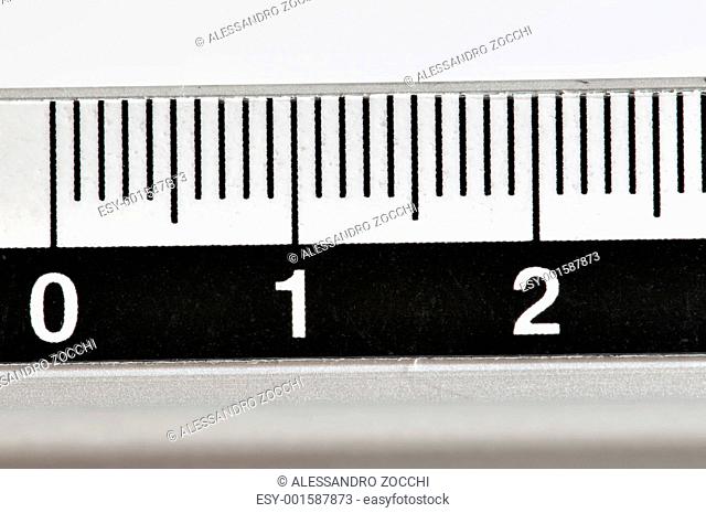 Metallic ruler in centimeters with white numbers and black markings