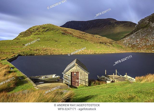 A boat house on the southern side of Llyn Dywarchen in the Snowdonia National Park in North Wales captured using a long shutter seed to blur the movement in the...