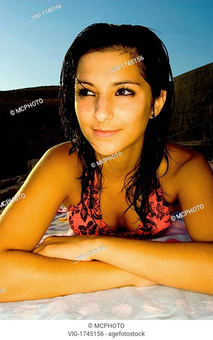 An attractive young model relaxing on her towel by the sea in Malta. - 28/07/2007