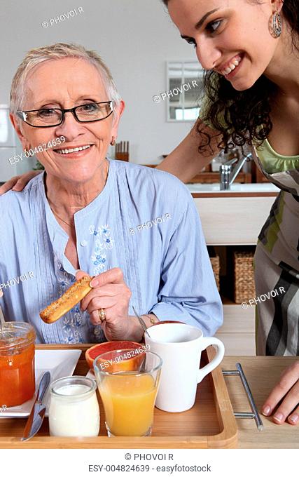 Woman serving breakfast to another woman