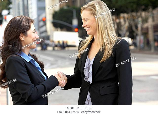 Two Businesswomen Shaking Hands Outside Office