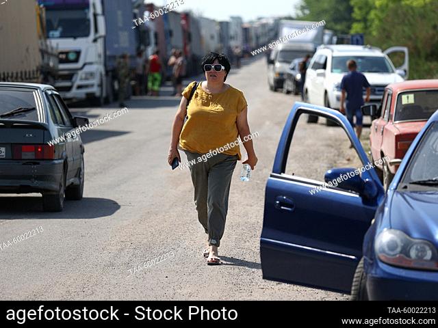 RUSSIA, KHERSON REGION - JUNE 23, 2023: Pedestrians and vehicles queue to pass the Armyansk checkpoint between the Kherson Region and Crimea