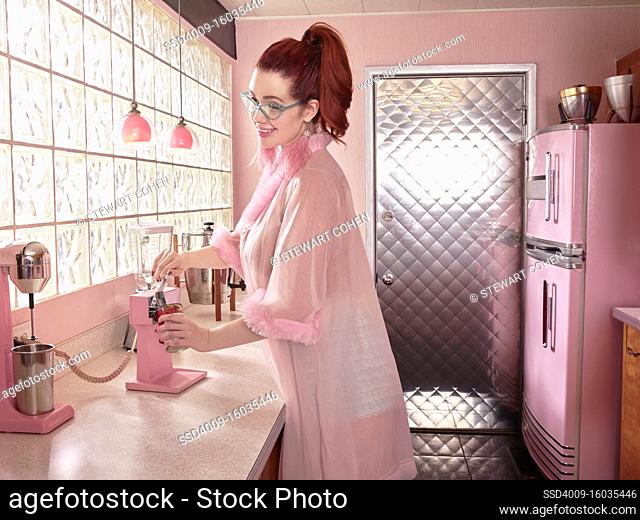 Vintage-styled portrait of woman using can opener in a mid-century kitchen