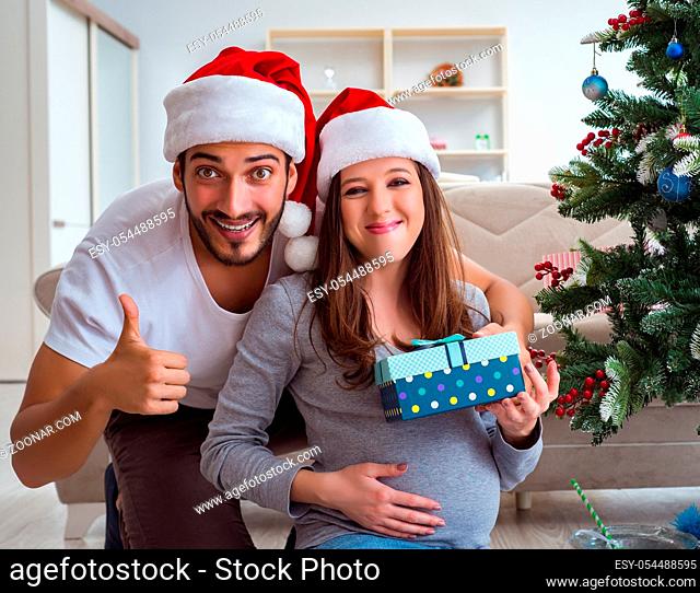 The young family expecting child baby celebrating christmas