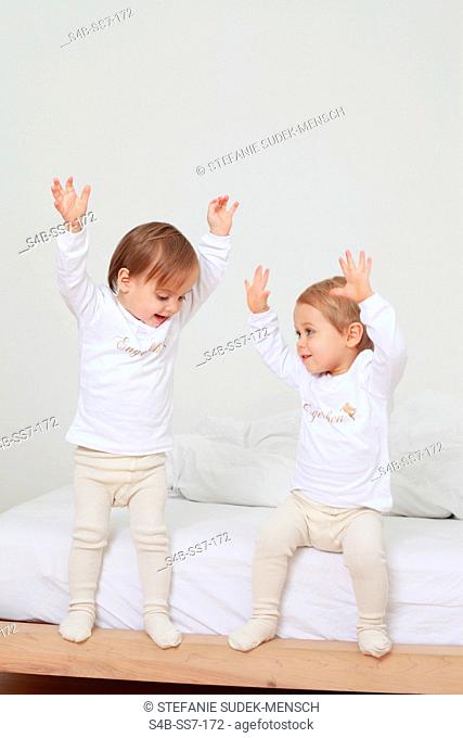 Two toddlers raising their arms, Berlin, Germany
