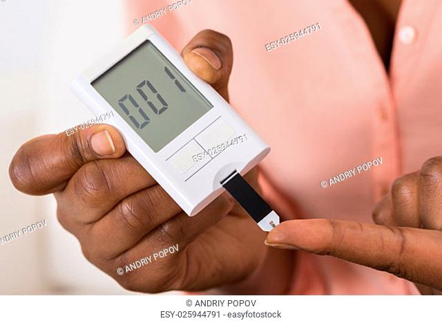Close-up Of Hand Holding Device For Measuring Blood Sugar