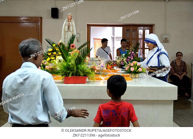 Visitors praying on the tomb of Mother Teresa in Mother House, Kolkata, India