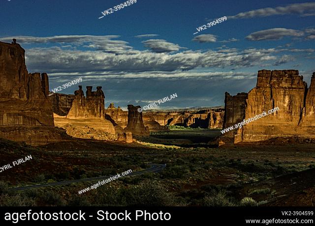 The valley and rock formations are key attractions in Arches Nat Park, Utah. The three pedestals at left are called the three gossips