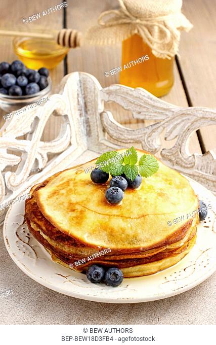 Stack of pancakes with syrup and blueberries. Party dessert