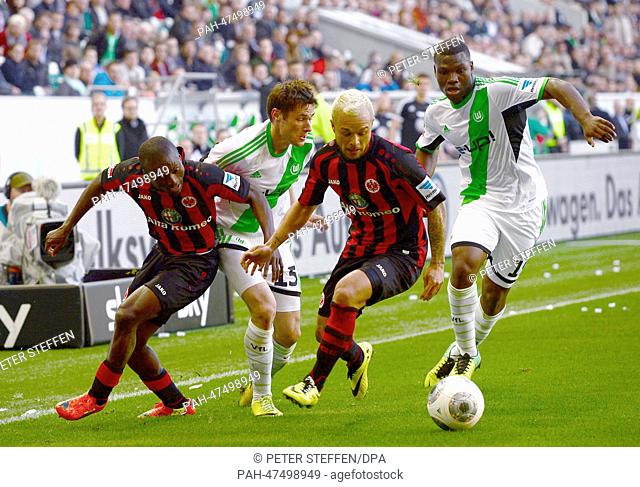 Wolfsburg's Christian Träsch (2-L) and Junior Malanda (R) vie for the ball with Frankfurt's Constant Djakpa (L) and Stephan Schroeck during the Bundesliga...