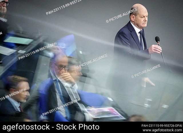 15 November 2023, Berlin: Federal Chancellor Olaf Scholz (above, SPD) speaks during the government questioning in the Bundestag while Christian Lindner (l, FDP)