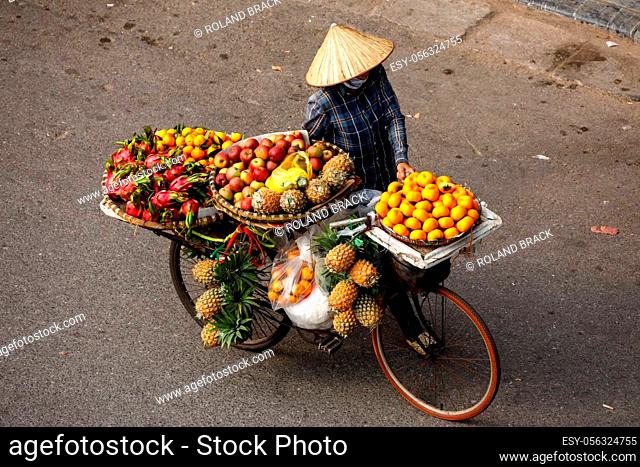 Transport of fruits on a bicycle in the streets of Hanoi in Vietnam