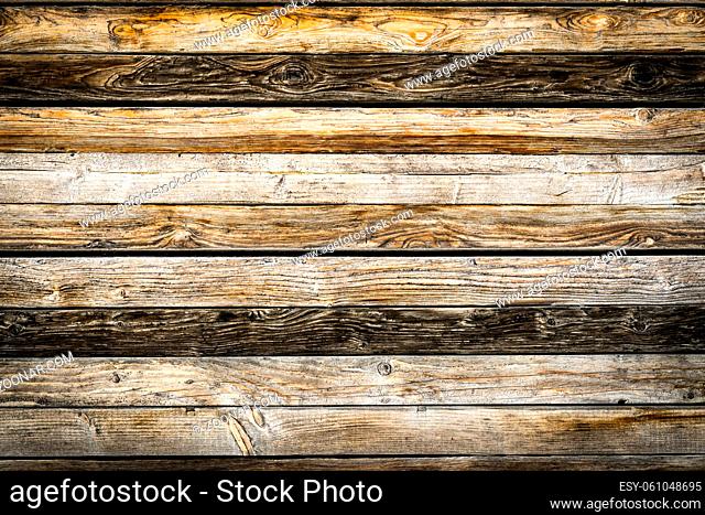 Old weathered brown barn wood wall. Wooden wall background design. Wood planks, boards are old with a beautiful rustic look