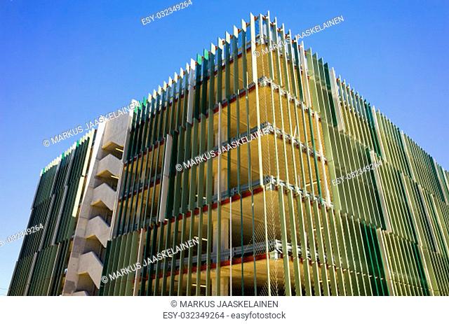 Multi-storey car park with many levels. Carpark building with multiple floors. Looking up at a tall automobile parking facility