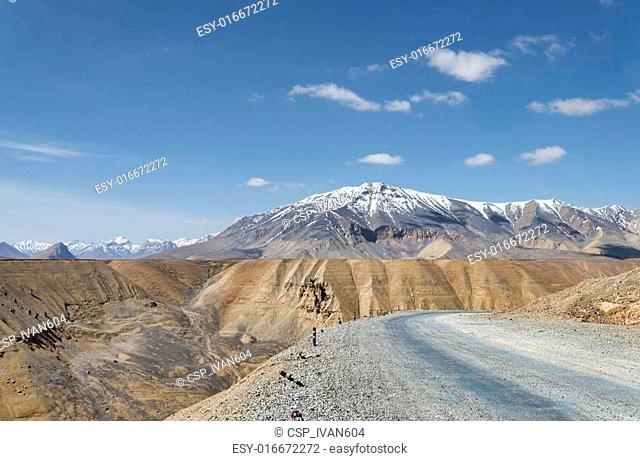 High altitude road with snow capped mountain background