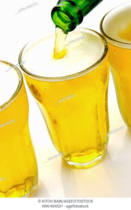Glasses of beer isolated against a white background