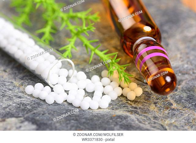 alternative medicine with herbal and homeopathic pills with essence from medicinal plant