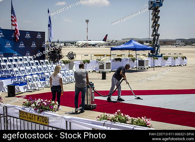 13 July 2022, Israel, Lod: Workers sweep a red carpet at Ben Gurion airport ahead of the arrival of US President Joe Biden for the state visit to Israel
