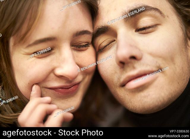 affectionate man putting a smile on women's face