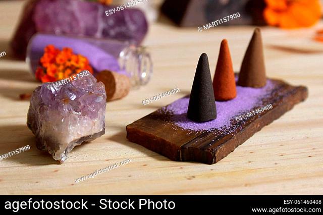 Incense Cones on Stone Slab With Rock Crystals and Flowers