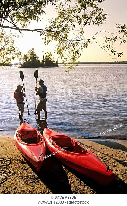 Couple with Kayaks, Otter Falls, Whiteshell Provincial Park, Manitoba, Canada
