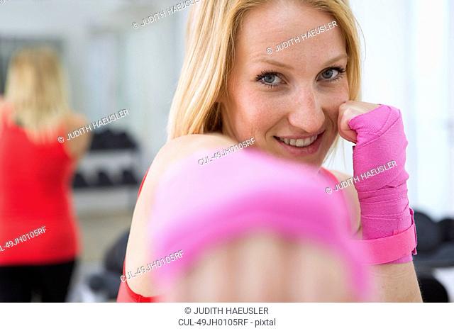 Boxer holding fists up in gym