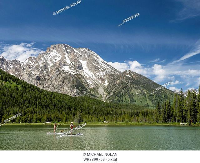 Stand up paddle boarders on String Lake, Grand Teton National Park, Wyoming, United States of America, North America