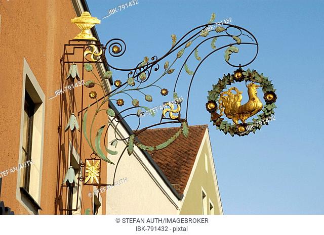 Old ornamental wrought iron restaurant sign, Goldener Hahn Inn, Schattenhofer Brewery in the historic centre of Beilngries, Altmuehltal Valley, Bavaria, Germany