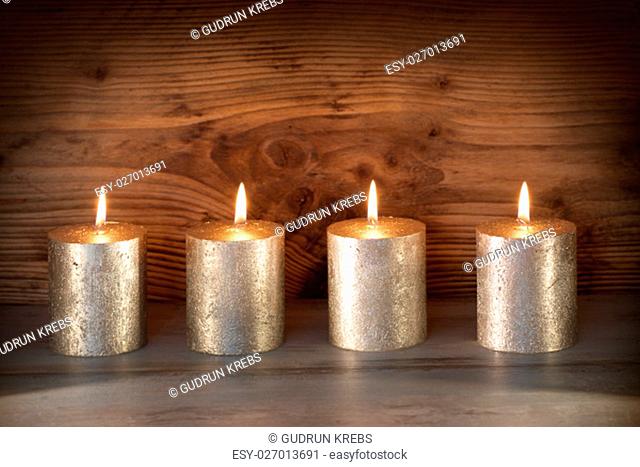 noble candles in front of a wooden background for celebratory moments