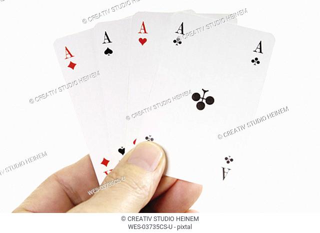 Person holding four aces, close-up