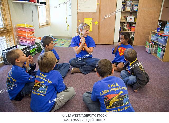 Alamosa, Colorado - An Americorps volunteer leads children in activities at PALS, an after-school program operated by La Puente  La Puente is a nonprofit agency...