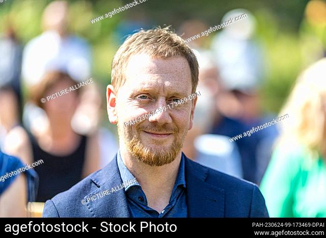 24 June 2023, Saxony, Bad Muskau: Michael Kretschmer (CDU), Prime Minister of Saxony, sits at the ceremony marking the 200th anniversary of the Hermannsbad in...