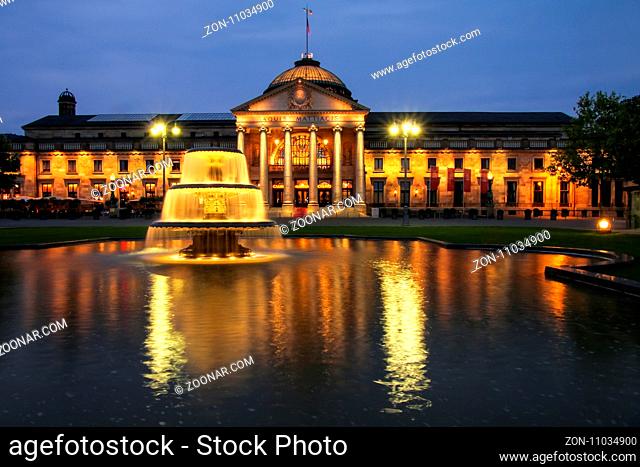 Kurhaus and Bowling Green in the evening with lights, Wiesbaden, Hesse, Germany. Wiesbaden is one of the oldest spa towns in Europe