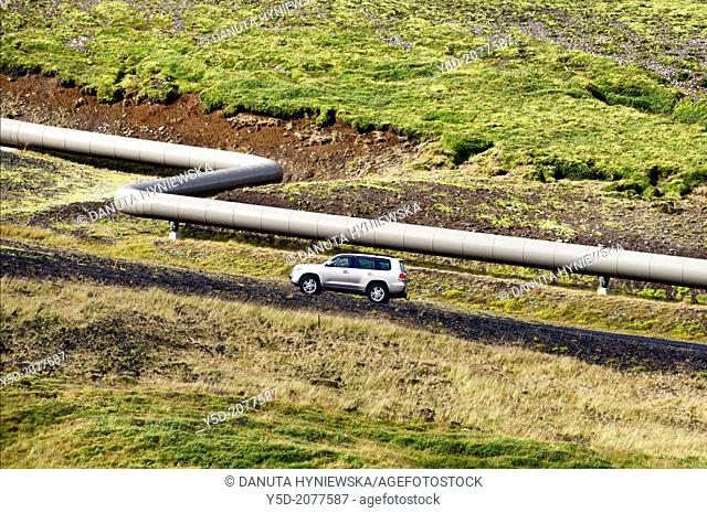 truck - most popular car in Iceland, pipe with hot water from geothermal power plant along the road, inland of Iceland