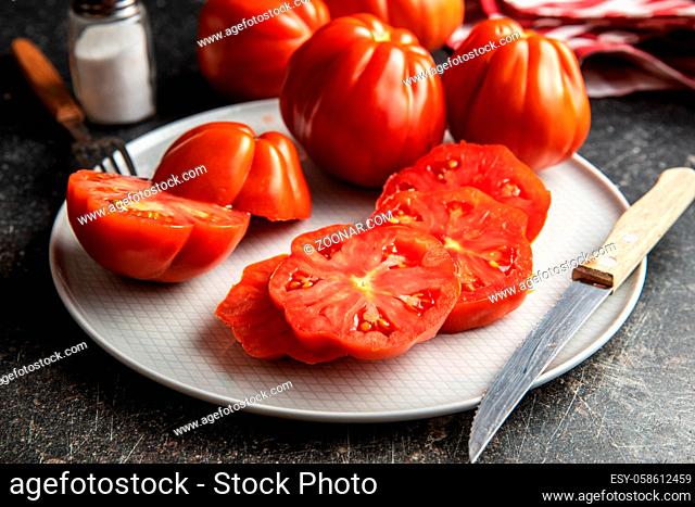 Red beefsteak tomatoes on plate