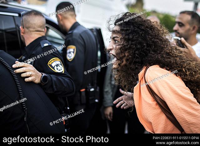 31 August 2022, Israel, Be'er Ya'akov: An activist shouts at police officers during a protest by Israeli left wing activists outside Shamir Medical Center...