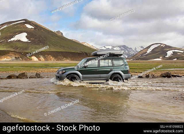 Jeep crossing a river in the high mountains of Landmannalaugar, Fjallabak National Park, Iceland