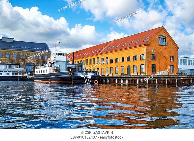 The moored ship near quaysidenear with red roof house in Copenha