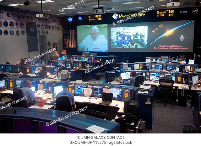 This overall view of the space shuttle flight control room in the Mission Control Center at NASA's Johnson Space Center was taken during a special call from...